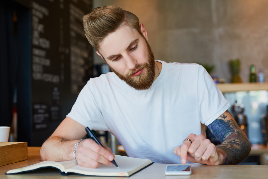 Coffee shop owner calculate business finance at the counter