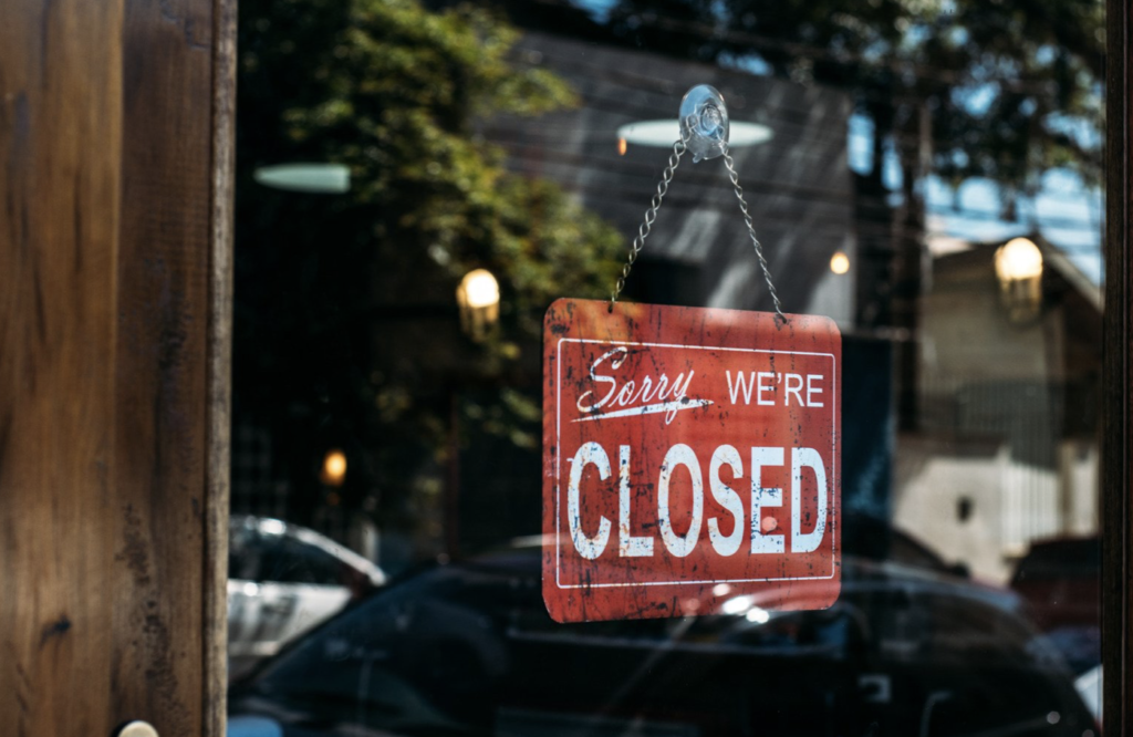 Small business "Sorry, we're closed." sign displayed