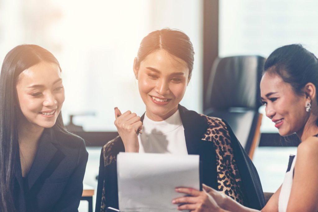 Three young business women of color applying for a small business loan