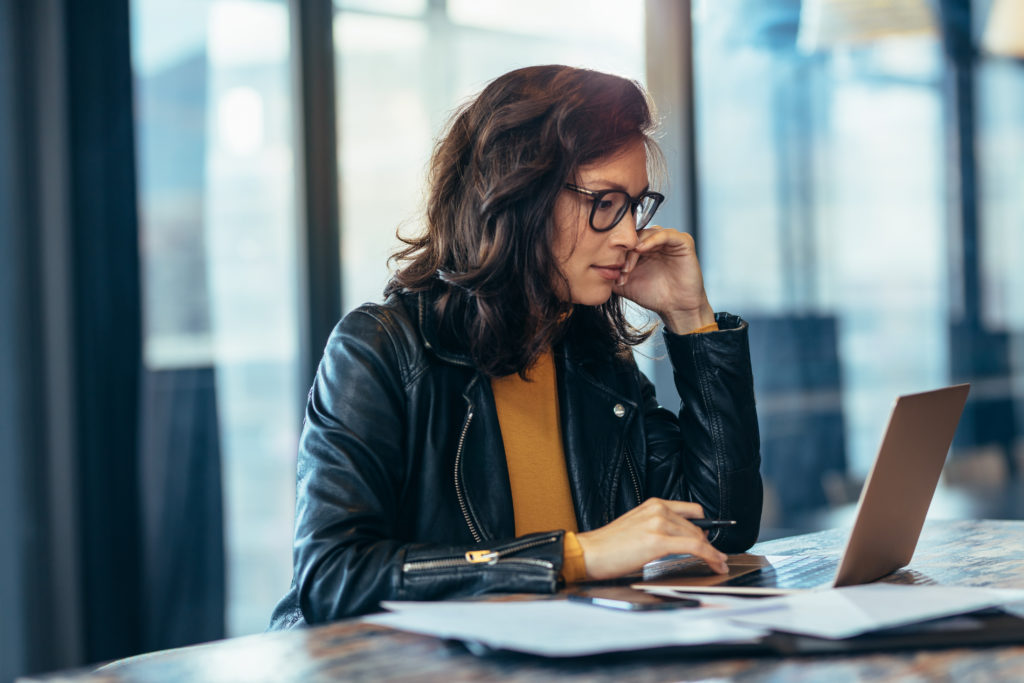 Asian business woman in casuals working at office