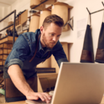 Small business owner working on administrative tasks in the shop backroom